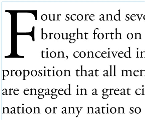 Sample serif text with three-line drop cap