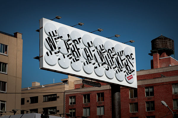 Photograph of a billboard with jumbled letters written across a grid of gears