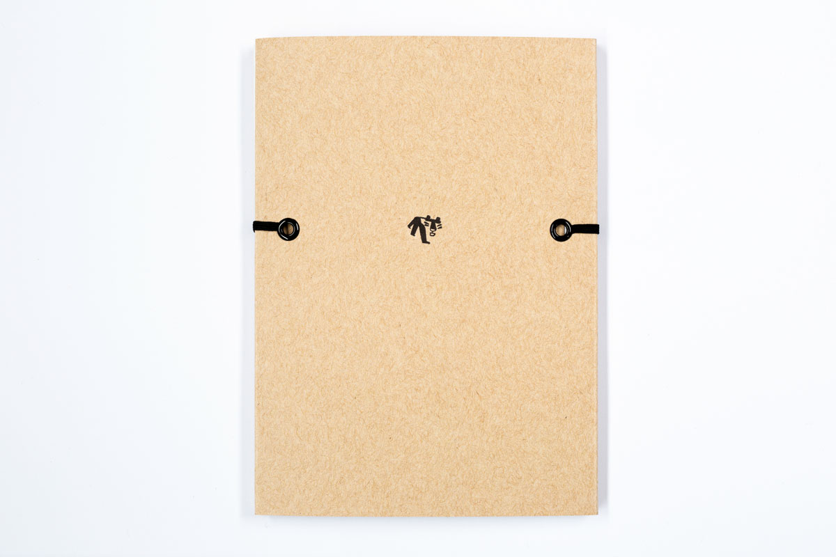 Figure 12: On the back cover of Calabria Upon Return, eyelets for the elastic band create an implied line with the logo for Paper Tiger Books.