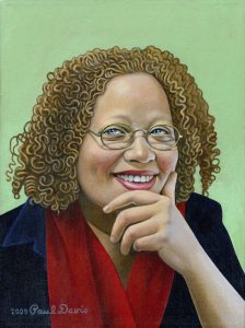 Portrait of woman with tightly curled hair and glasses