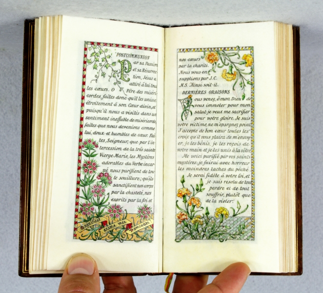 Book with initials and borders decorated with plants and flowers