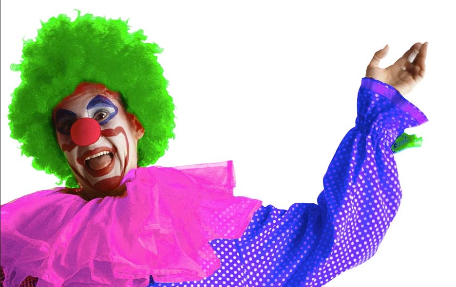 Photo of clown with bright green hair and bright pink and purple shirt