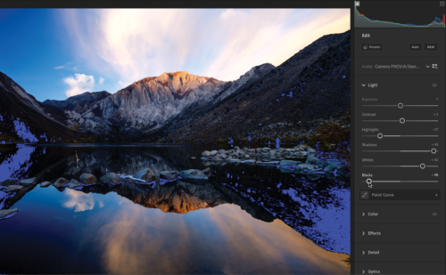 Image of mountain and body of water with total black shadows recolored blue