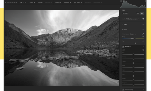 A black-and-white version of the same mountain and water body.