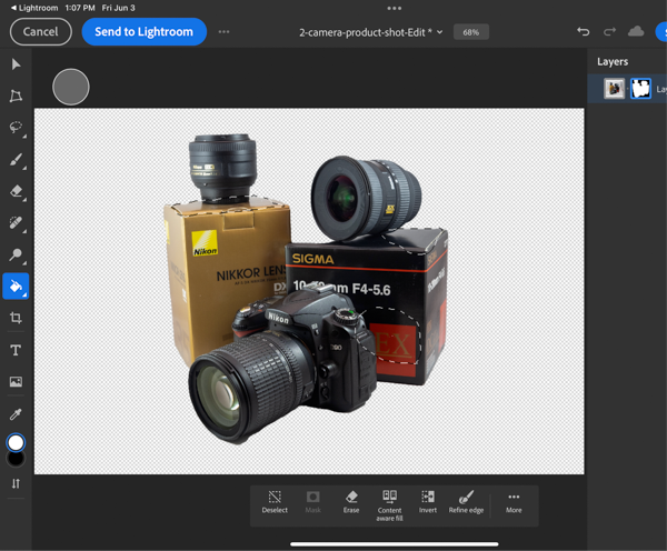 Photoshop screen shot with open image of cameras, lenses, and related equipment against white background.