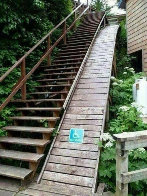 photo of stairway and adjacent ramp which is much too steep to be used by someone in a wheelchair