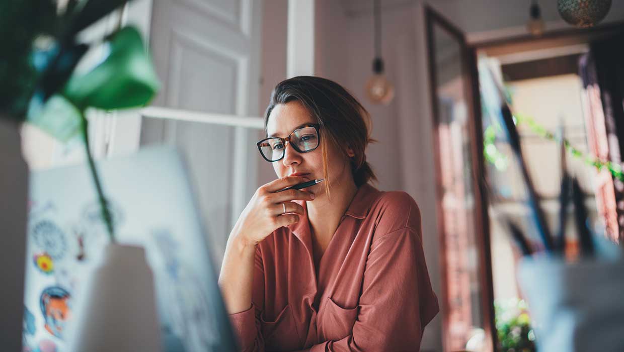 designer looking at computer screen and thinking