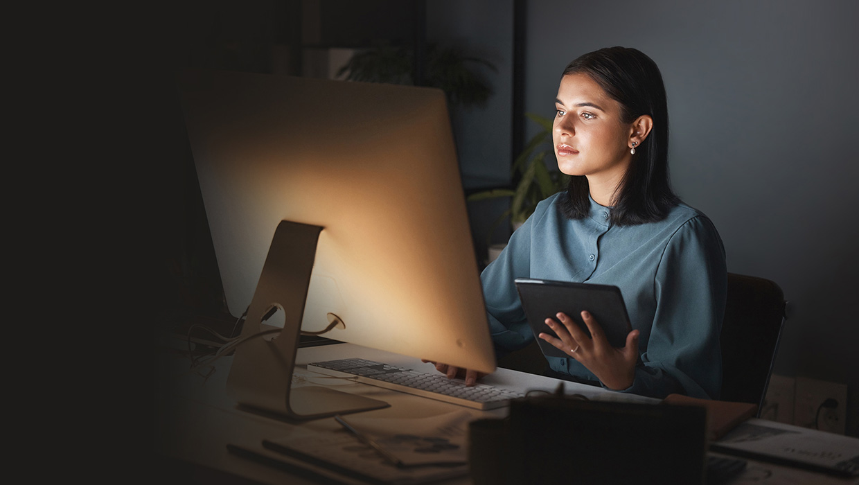 woman using Apple computer and iPad