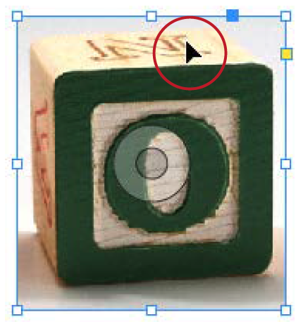 Photo of children's wooden block with green "O" on its face is selected. Direct Selection Tool icon highlighted in image with red circle.