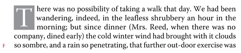 Five lines of text with three-line serif drop cap that is reversed out of a grey tint box.