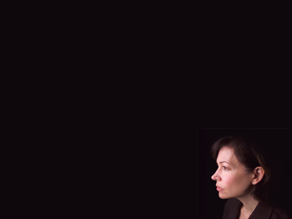 woman's side profile against black background