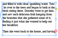 Selected text frame filled and showing overset marker on out port